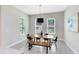 Bright dining room with a modern table, a bench, and lots of natural light from the large windows at 977 Talon Pl, Winter Springs, FL 32708