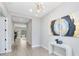 Inviting foyer with neutral walls, wood-look tile flooring, modern chandelier, and stylish decor, creates a bright and welcoming space at 977 Talon Pl, Winter Springs, FL 32708