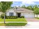 Charming home featuring a manicured front yard, brick driveway, and a two-car garage at 977 Talon Pl, Winter Springs, FL 32708