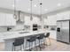 Bright kitchen featuring an expansive island, sleek stainless steel appliances, and ample white cabinetry, creating a stylish area at 977 Talon Pl, Winter Springs, FL 32708