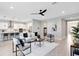 Spacious open-concept living area featuring modern decor, flowing into a sleek kitchen, perfect for seamless entertaining at 977 Talon Pl, Winter Springs, FL 32708