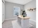 Minimalist office space featuring modern desk, chair, neutral decor, large window, and ample lighting for a productive atmosphere at 977 Talon Pl, Winter Springs, FL 32708