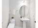 Well-lit powder room featuring a pedestal sink, oval mirror, toilet, neutral walls, and tasteful decor, offering a clean design at 977 Talon Pl, Winter Springs, FL 32708