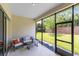 Relaxing screened patio with comfortable seating and views of the well-maintained backyard at 977 Talon Pl, Winter Springs, FL 32708