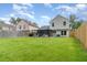 Open backyard with a privacy fence, screened patio area, and ample space for recreation at 1033 Mccully Ct, Oviedo, FL 32765