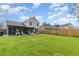 Spacious backyard featuring a well-maintained lawn, screened-in porch, and full privacy fence at 1033 Mccully Ct, Oviedo, FL 32765