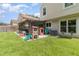 Large backyard featuring a screened patio, play area, and lush green grass at 1033 Mccully Ct, Oviedo, FL 32765