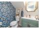 Stylish half bathroom showcasing bold wallpaper, modern fixtures, and a green vanity at 1033 Mccully Ct, Oviedo, FL 32765