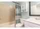 Bathroom with a shower-tub combo, complemented by blue accents and functional storage at 1033 Mccully Ct, Oviedo, FL 32765
