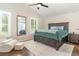 A sophisticated bedroom with a wooden platform bed, plush carpet, and ample natural light at 1033 Mccully Ct, Oviedo, FL 32765