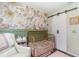 A serene Bedroom with floral wallpaper, offering a tranquil space for rest and relaxation at 1033 Mccully Ct, Oviedo, FL 32765