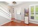 Inviting foyer featuring wood-look floors, staircase, and a decorative ladder for blankets at 1033 Mccully Ct, Oviedo, FL 32765