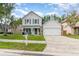 Charming two-story home featuring stone accents, a covered porch, and a well-maintained lawn at 1033 Mccully Ct, Oviedo, FL 32765