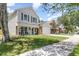 Two-story home with neutral siding, stone accents, covered porch, and a well-kept lawn at 1033 Mccully Ct, Oviedo, FL 32765