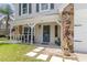 Charming front porch with seating, stone pillars, and a welcoming entrance to the home at 1033 Mccully Ct, Oviedo, FL 32765