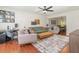 Spacious living room with ample seating, a ceiling fan, and wood-look floors at 1033 Mccully Ct, Oviedo, FL 32765