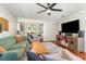 Inviting living room with plush seating, a ceiling fan, and a view of the dining area at 1033 Mccully Ct, Oviedo, FL 32765