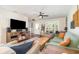 Open-concept living room with wood-look floors, comfortable seating, and natural light at 1033 Mccully Ct, Oviedo, FL 32765