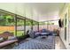 Relaxing screened-in patio with comfortable seating and a view of the backyard at 1033 Mccully Ct, Oviedo, FL 32765
