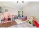 Bright playroom, filled with various toys, playhouse, and an area rug at 1033 Mccully Ct, Oviedo, FL 32765