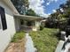 The backyard has overgrown grass and a covered patio area at 1047 Clay Blvd, Eustis, FL 32726