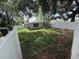 View of the backyard with partial privacy fence and lots of trees at 1047 Clay Blvd, Eustis, FL 32726