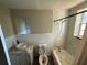 Bathroom featuring a shower/tub combo and a ceramic sink with open storage at 1047 Clay Blvd, Eustis, FL 32726