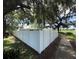 Exterior view of the property with a white vinyl fence surrounding the perimeter at 1047 Clay Blvd, Eustis, FL 32726