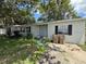 View of the front of the home including windows with dark shutters and a simple concrete driveway at 1047 Clay Blvd, Eustis, FL 32726