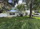 Charming home with mature trees and a well-lit exterior at 1047 Clay Blvd, Eustis, FL 32726