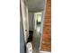 Hallway with wood-look tile and views into adjacent rooms and closets at 1047 Clay Blvd, Eustis, FL 32726