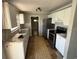 Galley kitchen with stainless steel appliances, white cabinets, and formica countertops at 1047 Clay Blvd, Eustis, FL 32726