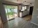 Kitchen with sliding glass door to backyard and white cabinets at 1047 Clay Blvd, Eustis, FL 32726