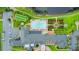 Overhead view of clubhouse showing a pool, gardens, tennis courts and parking at 1104 Sawgrass Dr, Winter Haven, FL 33884