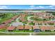 A panoramic aerial view showcasing community homes and a serene lake at 1104 Sawgrass Dr, Winter Haven, FL 33884