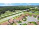 An aerial view of houses, golf course, and scenic surroundings at 1104 Sawgrass Dr, Winter Haven, FL 33884