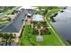 Community clubhouse aerial view with pool, gardens, lawn chess, and lake at 1104 Sawgrass Dr, Winter Haven, FL 33884