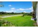 Expansive backyard view featuring a lush green lawn, meticulous landscaping, and a peaceful atmosphere at 1104 Sawgrass Dr, Winter Haven, FL 33884
