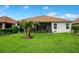 Spacious backyard showcasing a well-maintained lawn, landscaping, and a screened-in patio, perfect for outdoor living at 1104 Sawgrass Dr, Winter Haven, FL 33884