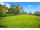 Large grassy backyard offering plenty of space for recreation, gardening, and outdoor enjoyment at 1104 Sawgrass Dr, Winter Haven, FL 33884