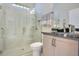 Bright bathroom featuring glass shower and white cabinets with granite countertops at 1104 Sawgrass Dr, Winter Haven, FL 33884