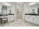 Dual sink bathroom with a walk-in shower, white cabinets, and granite countertops at 1104 Sawgrass Dr, Winter Haven, FL 33884