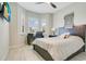 Comfortable bedroom featuring hardwood floors, a ceiling fan and a TV at 1104 Sawgrass Dr, Winter Haven, FL 33884