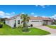Charming single-story home with well-manicured lawn and a three-car garage at 1104 Sawgrass Dr, Winter Haven, FL 33884