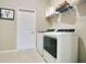 Functional laundry room featuring modern washer and dryer appliances at 1104 Sawgrass Dr, Winter Haven, FL 33884