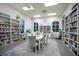 Charming library featuring bookshelves filled with books, comfortable seating, and abundant natural light at 1104 Sawgrass Dr, Winter Haven, FL 33884