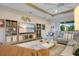 Spacious living room featuring a large sectional, built-in shelving, and a modern ceiling fan at 1104 Sawgrass Dr, Winter Haven, FL 33884