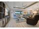 Open-concept living room with stylish furniture, wood floors, and abundant natural light at 1104 Sawgrass Dr, Winter Haven, FL 33884