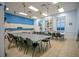 Bright meeting room featuring rows of tables and chairs plus a kitchen area with ample counter and cabinet space at 1104 Sawgrass Dr, Winter Haven, FL 33884