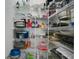 Organized pantry with wire shelving, storing various kitchen items and appliances at 1104 Sawgrass Dr, Winter Haven, FL 33884